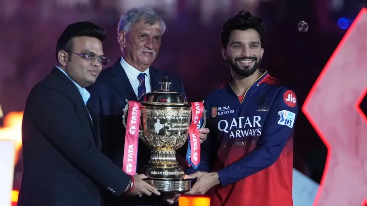 Rajat Patidar getting the IPL trophy from Jay Shah