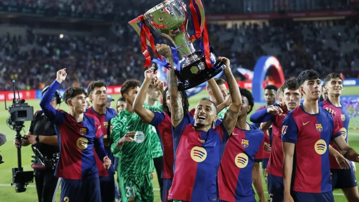 Raphinha celebrates with the La Liga title.