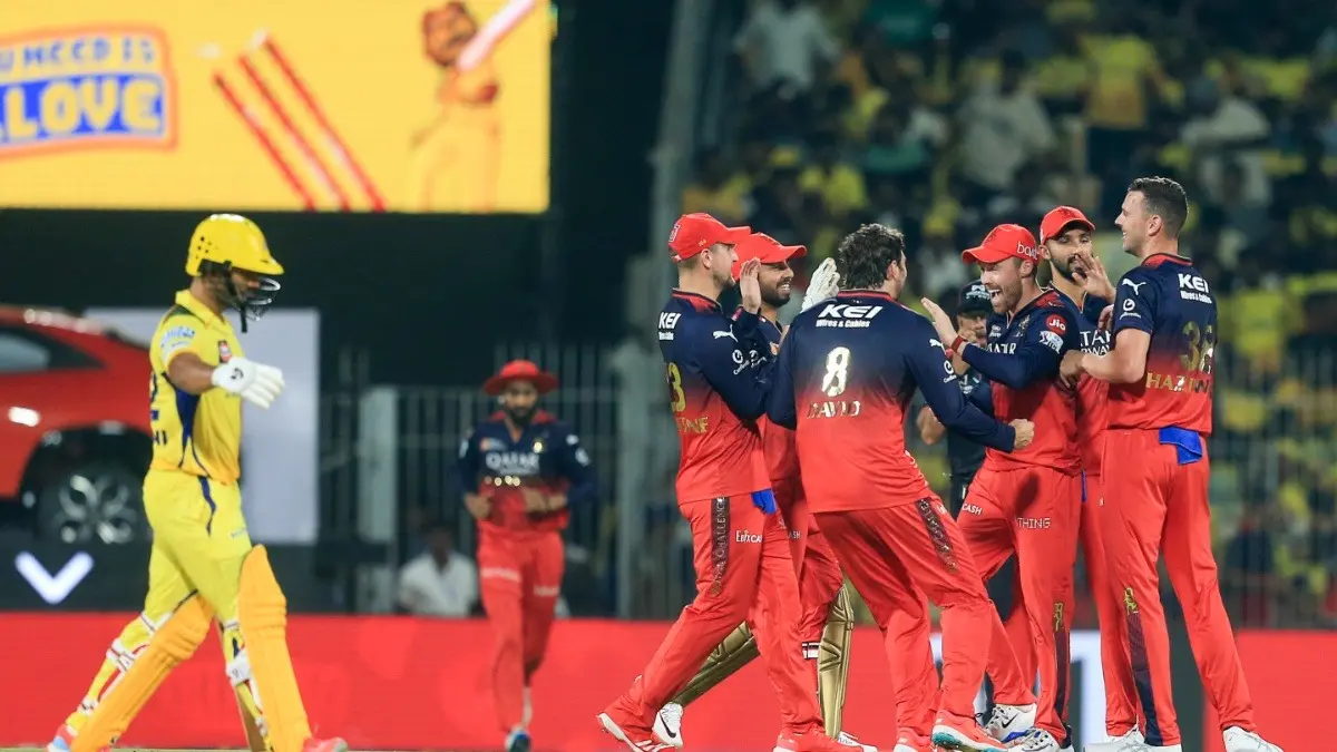 RCB players celebrate the dismissal of CSK's Rahul Tripathi