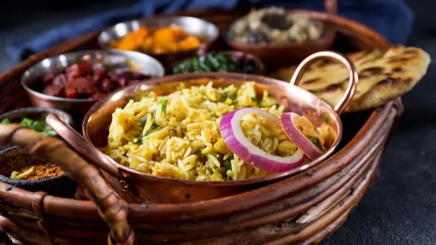 Andhra Pradesh’s Must Try Delicacies: Pulihora, Pesarattu, Chepa Pulusu, Gutti Vankaya Kurra, Pootharekulu And More Representative image for Andhra cuisine