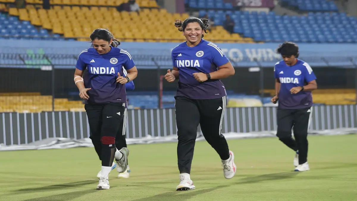 Richa Ghosh and Smriti Mandhana warm up during a practice session