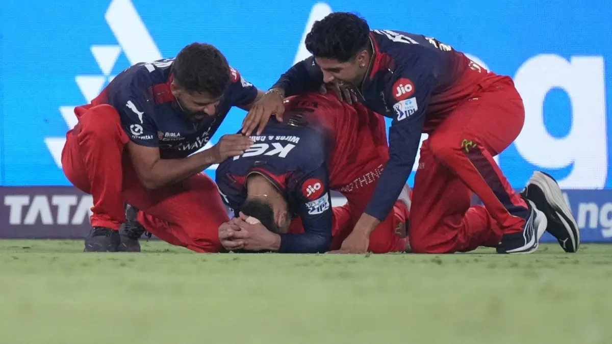 Royal Challengers Bengaluru's Virat Kohli, center, breaks down after winning maiden IPL title win