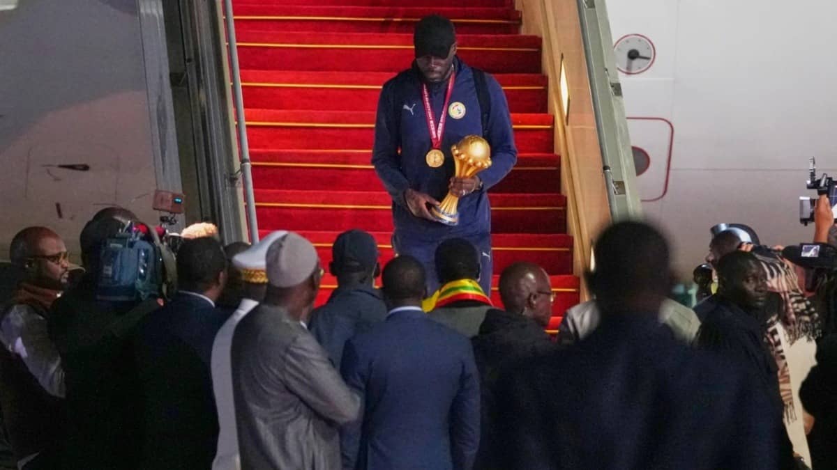 Senegal's Kalidou Koulibaly holds the AFCON Trophy after winning team reach in Dakar