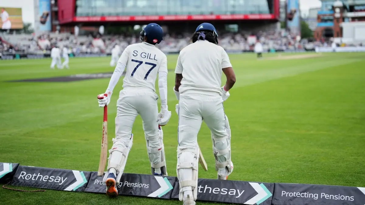 Shubman Gill and KL Rahul walk out to bat on the fifth day of the Manchester Test