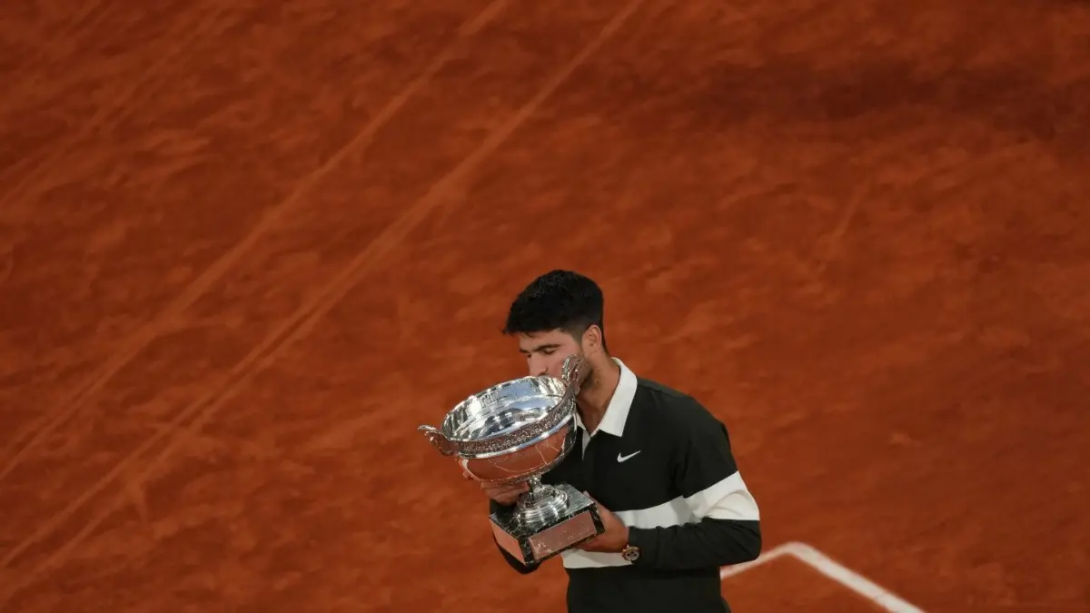 Spain's Carlos Alcaraz holds the trophy after winning the final match of the French Open 2025