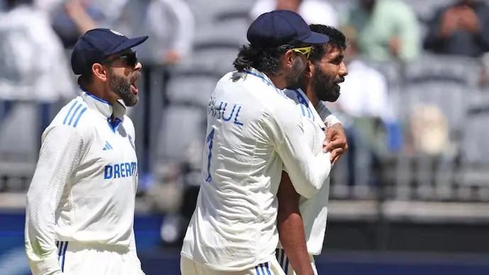 Virat Kohli, KL Rahul and Jasprit Bumrah celebrate Travis Head's wicket.