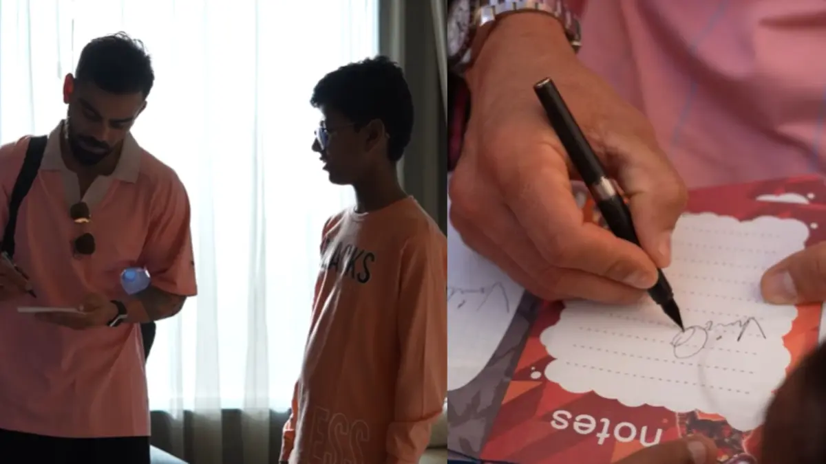 Virat Kohli signs autograph for young kid