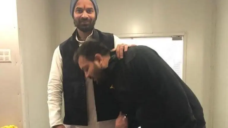 Tejashwi Yadav meets elder brother Tej Pratap after several months, touches his feet Tejashwi Yadav meets elder brother Tej Pratap after several months, touches his feet