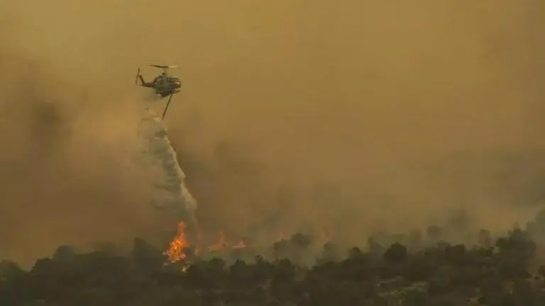 Deadly wildfires in Greece and other European countries threaten nature reserves A firefighting helicopter tackles the wildfires in Greece. Image: AP