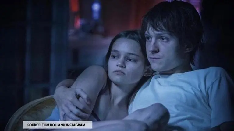 Tom Holland dons bank robber's maks, army suit & much more in new stills from 'Cherry' tom holland