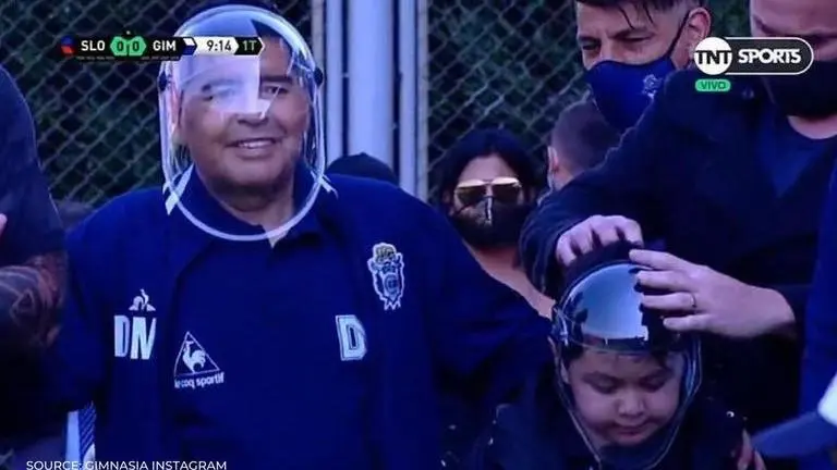 Diego Maradona wears ‘space-age’ face mask while watching Gimnasia during a friendly diego maradona