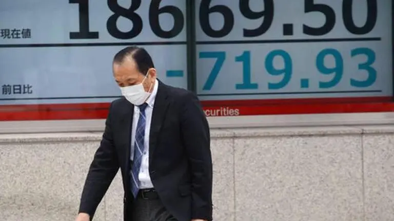 Asian shares extend losses as toll from pandemic surges