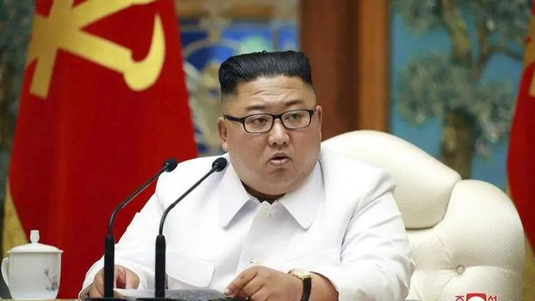 Kim Jong Un at politburo on flooding and virus