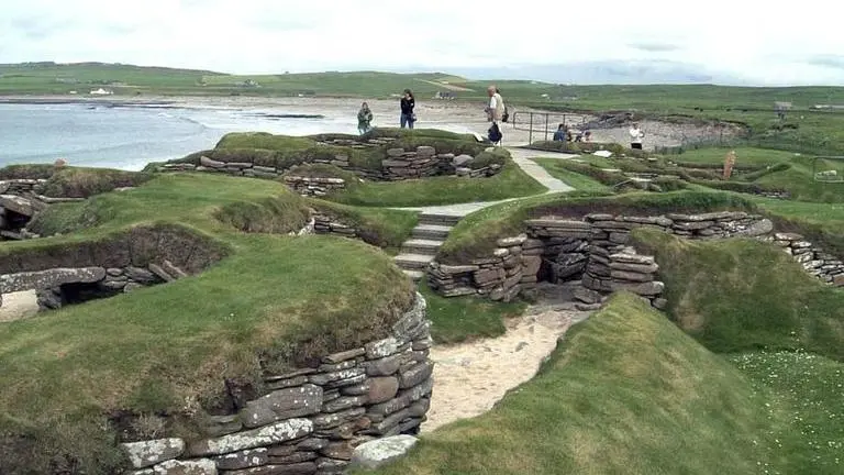 Visitors look at the 5,000 year-old remains of Skara Brae village in the Scottish Orkney Islands (Image: AP)