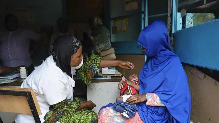 Power cuts in Niger threaten to spoil millions of vaccines amid sanctions, says UN Women gather at a clinic to have their children vaccinated in Niamey, Niger (Image: AP)