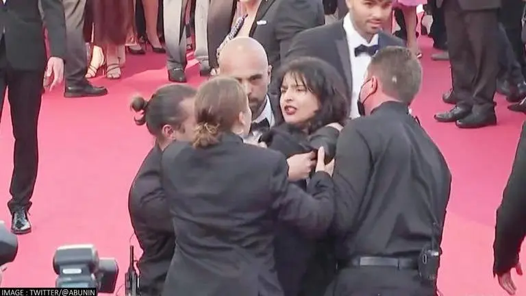 Topless woman crashes Cannes 2022 red carpet to protest against sexual violence in Ukraine Cannes 2022