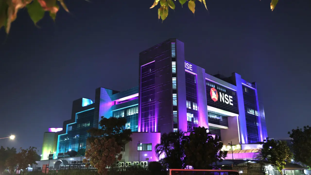 Why the NSE Has Recruited a Record-Breaking 20 Bankers to Manage Its ₹30,000 Crore IPO NSE headquarters building with symbols of stock market trading and investment banking.