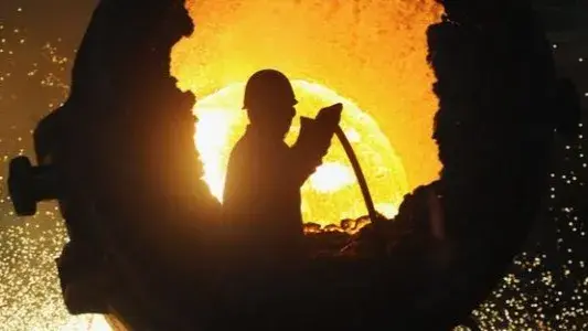 Slowing China still leads the race for commodities A worker operating a furnace at a steel plant in Hefei