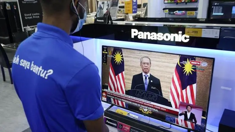 Malaysia approves virus emergency as cases surge