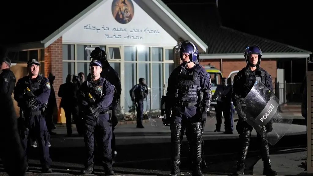 Police standing guard outside the Sydney church where the stabbing took place on Monday.