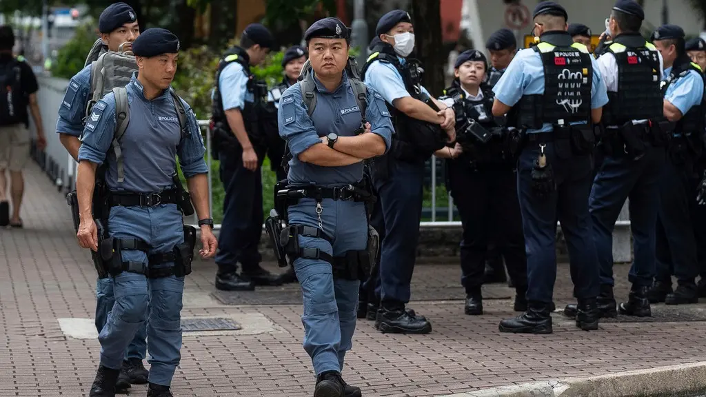 Police officers standing guard outside the West Kowloon Magistrates' Court in Hong Kong where the national security trial took place.