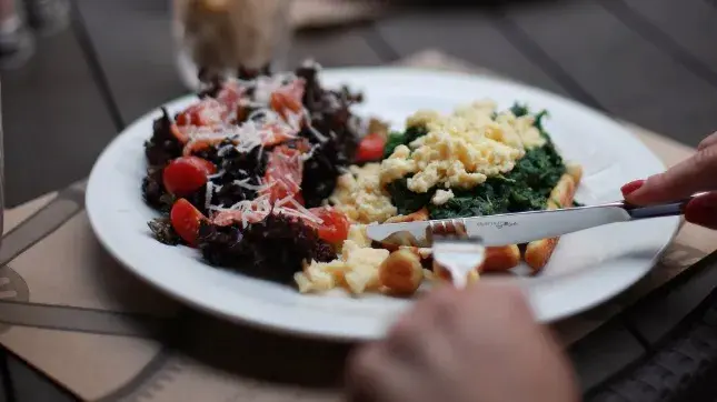 Kick off your week with a nutritious breakfast of scrambled eggs with spinach and tomatoes.
