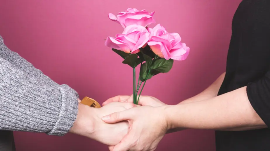 a couple holding flowers together