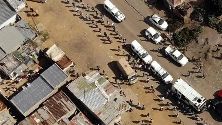 Thousands of hungry people line up for food in South Africa