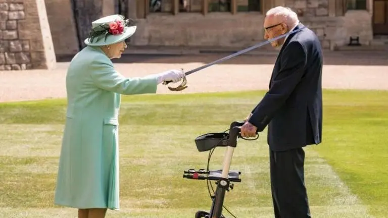 Queen Elizabeth confers knighthood on 100-year-old fundraiser captain Tom Moore Queen Elizabeth