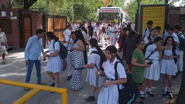 Students and parents outside Delhi Public School, Noida, after several schools received a bomb threat