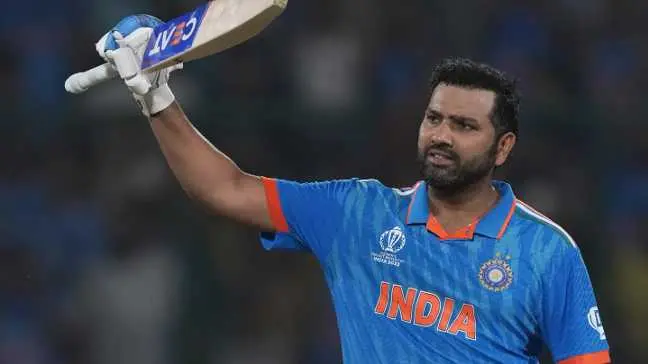 Rohit Sharma raises his bat in celebration after scoring a ton in the IND vs AFG ODI World Cup match