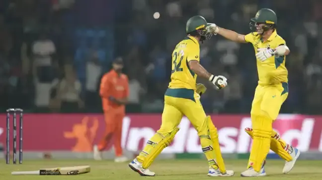 Pat Cummins and Glenn Maxwell hug it out during the ODI World Cup match