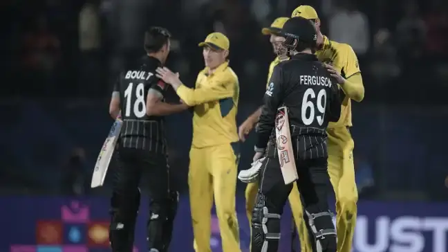 Australia and New Zealand players shake hands after the match