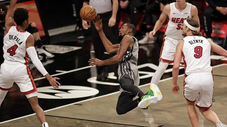 Harden, Durant help Nets break away late, beat Heat 98-85