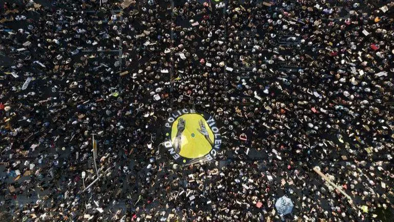 Protests turn subdued after new charges in Floyd case