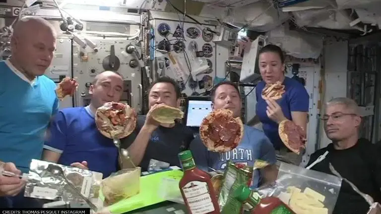 Astronaut enjoys pizza