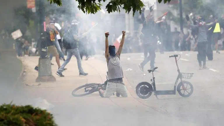 Riot police fire tear gas as protests continue