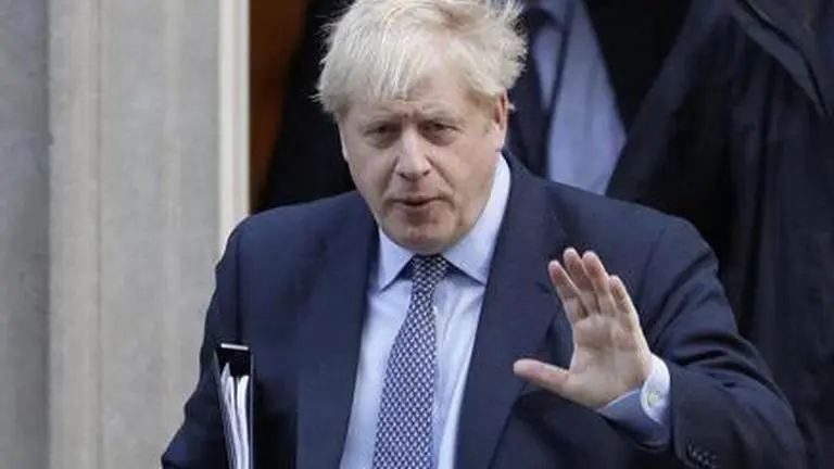 UK’s Johnson defends virus strategy as infections soar