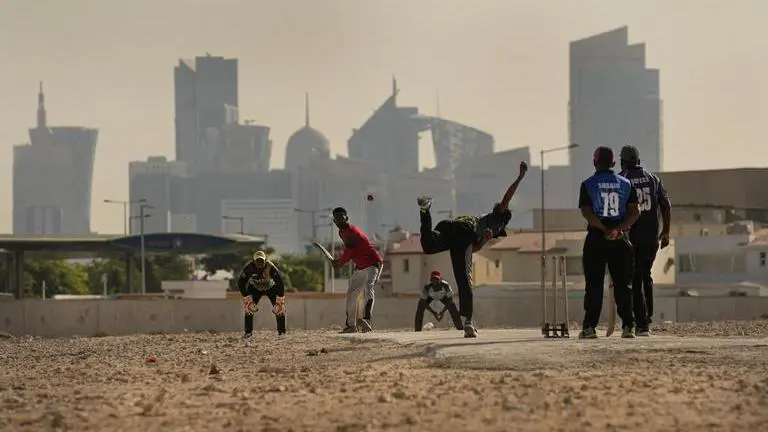Labourers in Qatar play sandlot cricket near World Cup soccer stadiums Qatar World Cup