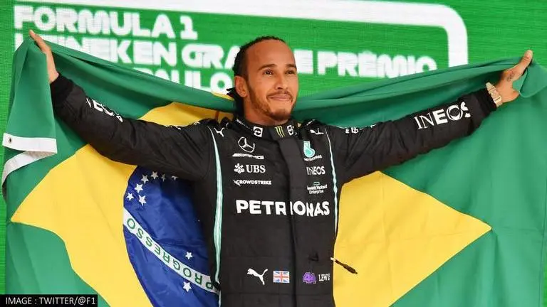 Brazilian GP: Lewis Hamilton fined for removing safety belts to pick Brazil flag post-race Lewis Hamilton fined for removing safety belts