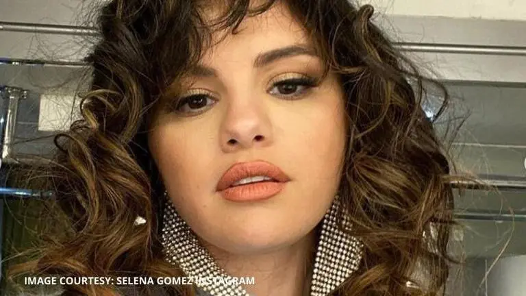 Selena Gomez's surprise song drop makes her "Dance Again" in white satin dress Selena Gomez