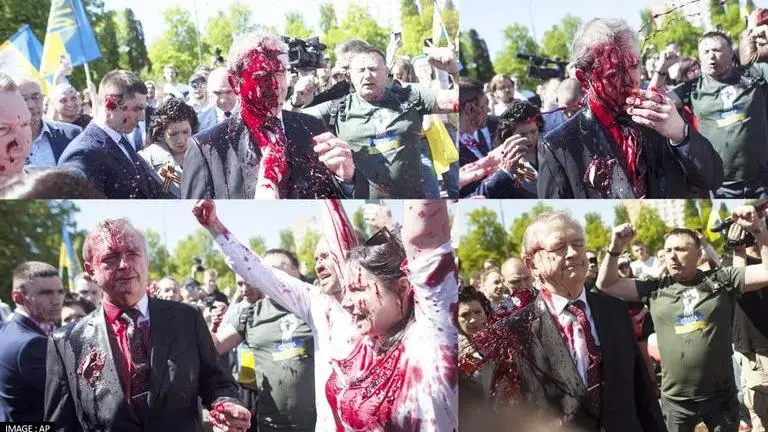 Protesters throw red paint at Russian envoy Sergey Andreev in Poland on Victory Day Victory Day
