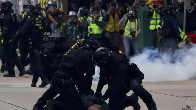 Hong Kong police fire tear gas as black-clad protesters return to streets Hong Kong