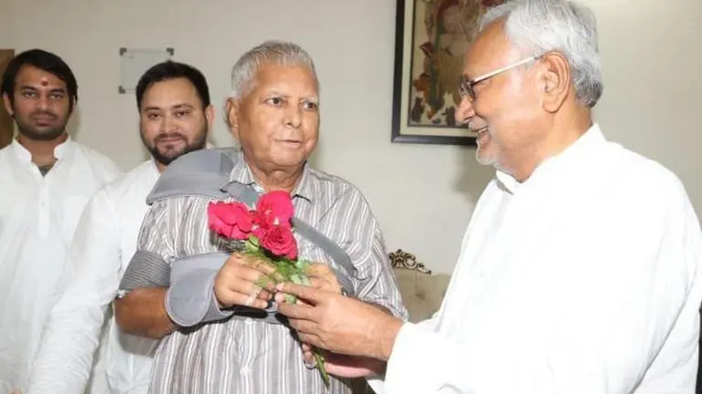 Bihar CM Nitish Kumar greets Lalu Yadav with roses on his arrival from Delhi after a month Nitish Kumar