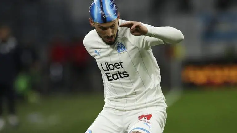 Marseille striker Benedetto wears swim cap after head injury