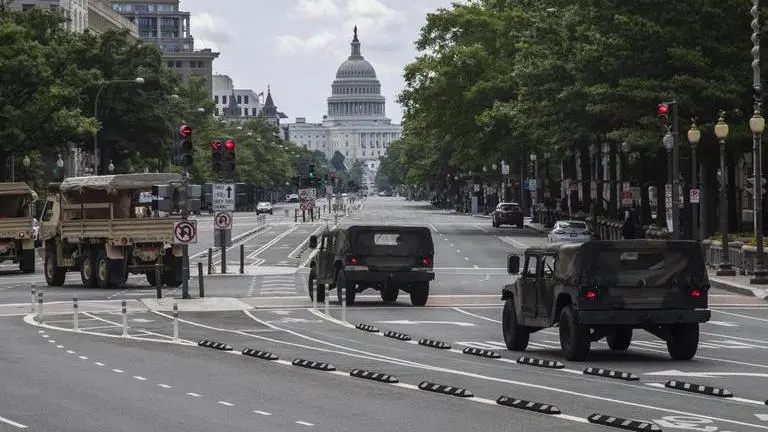 National Guard vehicles drive along Pennsylvania Avenue NW, as they prepare for protests and demonstrations
