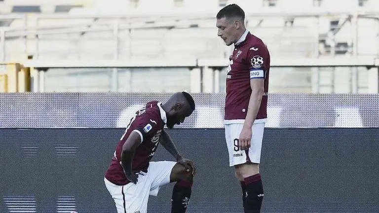 Torino scorer Nkoulou takes a knee as Serie A resumes