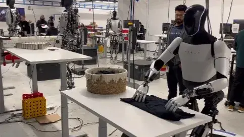 Elon Musk Unveils Tesla's Humanoid Robot, Optimus, Demonstrating Impressive Shirt-Folding Skills Elon Musk Unveils Tesla's Humanoid Robot, Optimus