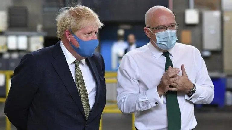 In reversal, UK says it will make masks mandatory in shops