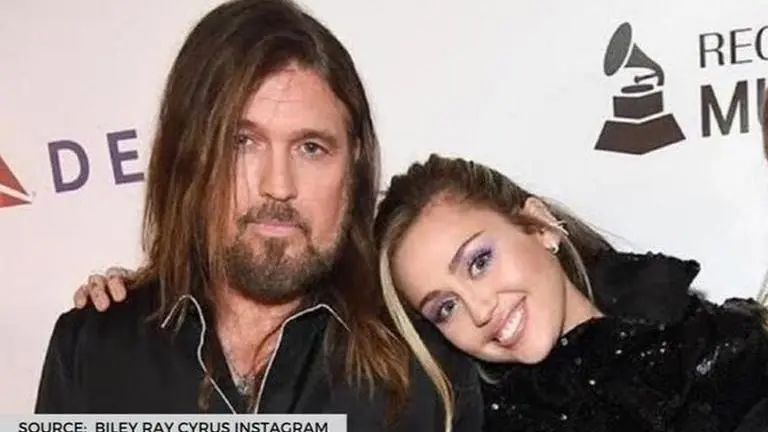 Miley Cyrus spills the beans on how her father is 'coping with his new iphone' Miley Cyrus